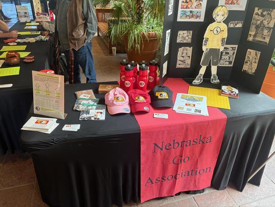 Our tables, with lots of swag and info about the game welcoming people to ask questions, learn