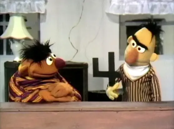 Bert and Ernie from Sesame Street staring quizzically at the number 4
