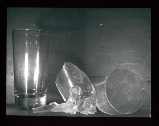 two drinking glasses side by side, one is broken.