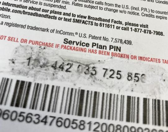 A close up of a scratch-off thing which shows the silver part scratched off along with some of the numbers
